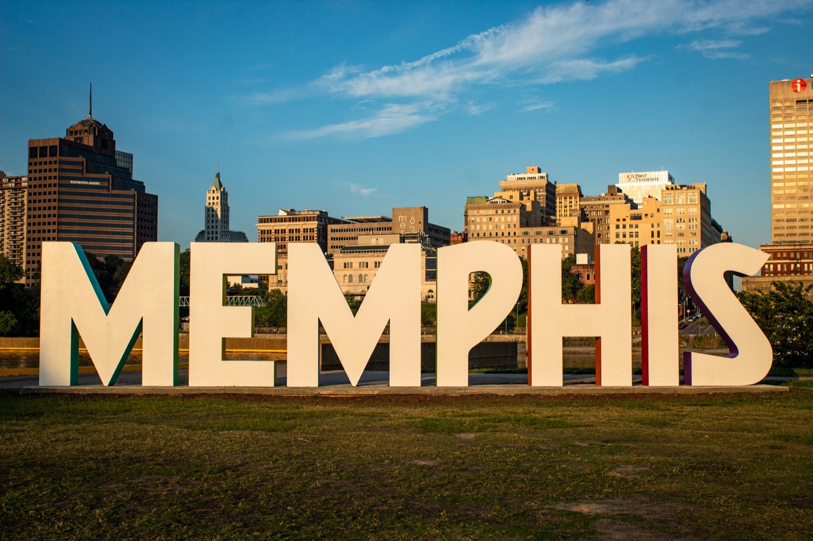 The Memphis sign with the downtown Memphis skyline behind it at golden hour